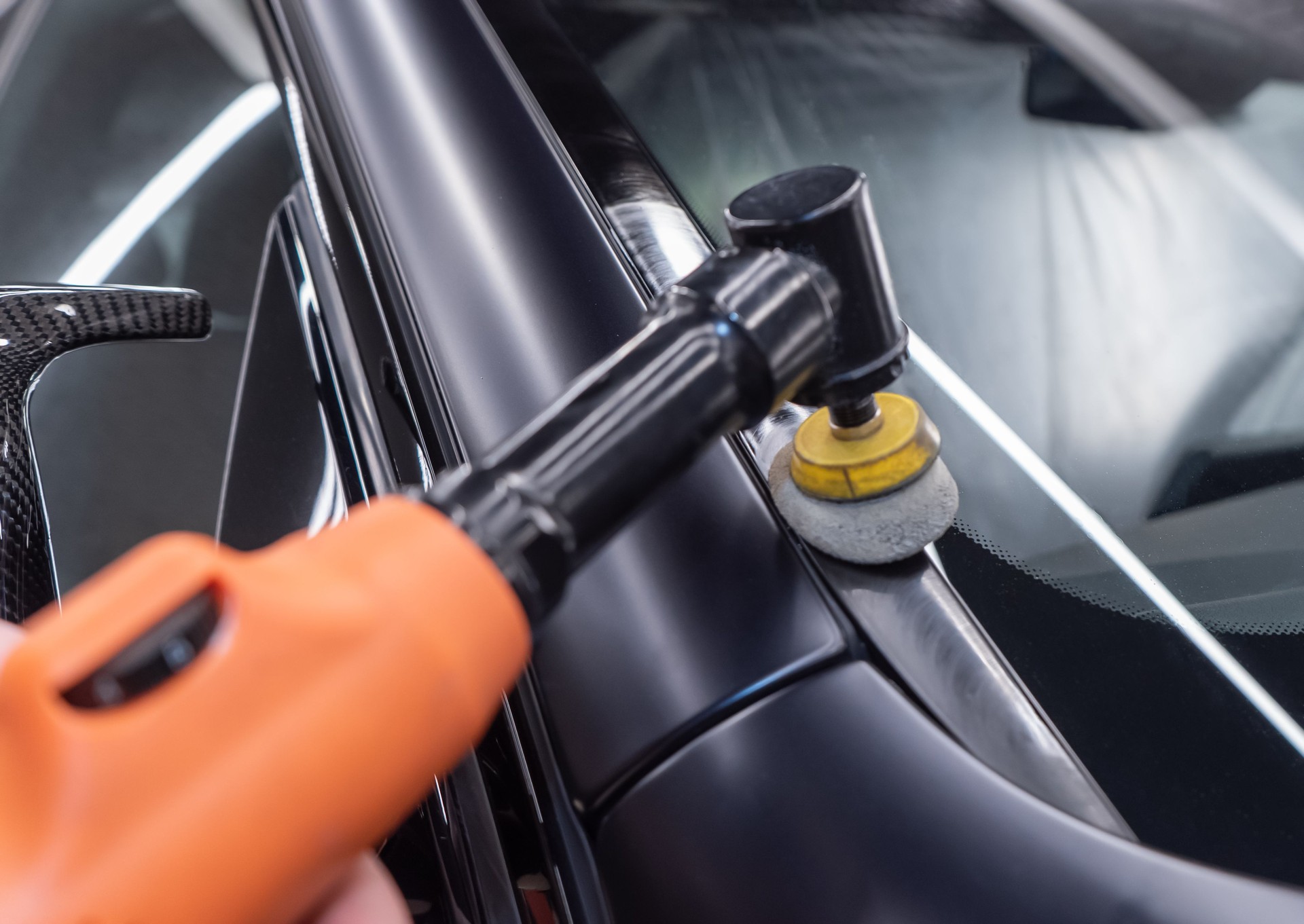 Car detailing series: Polishing gray car close-up. The process of polishing the car body in close-up.
